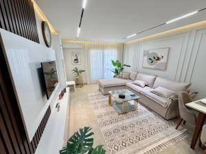a living room with a couch and a tv at LUXURY apartment October City in 6th Of October