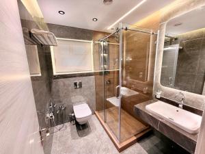 a bathroom with a shower and a toilet and a sink at LUXURY apartment October City in 6th Of October +33 photos