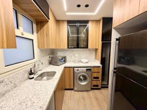 a kitchen with a sink and a washing machine at LUXURY apartment October City in 6th Of October
