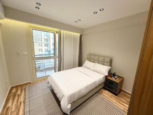 a small bedroom with a bed and a window at LUXURY apartment October City in 6th Of October