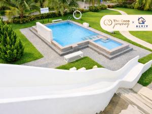 a villa with a swimming pool in a resort at The Coco Journey - Eco Tent in Kelebang Besar