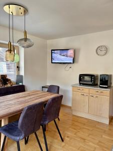 a dining room with a table and chairs and a microwave at Ferienwohnung Soller in Bramberg am Wildkogel