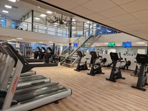 a gym with treadmills and elliptical machines at Hotel De Bonte Wever Assen in Assen