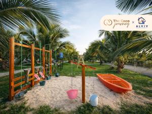 a playground with a boat and a swing at The Coco Journey - Eco Tent in Kelebang Besar