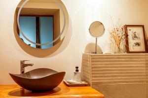 a bathroom with a black chair and a mirror at La Maison Bakéa in Cordes-sur-Ciel +53 photos