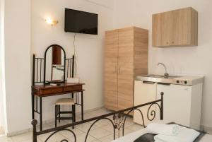 a room with a sink and a table and a kitchen at Aegean Nest Beach Studios - Adults only in Monolithos +37 photos