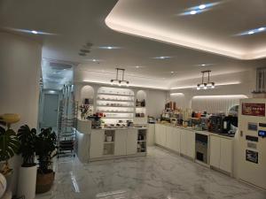 a large kitchen with white cabinets and a counter at Daegu lily Residence Hotel in Daegu