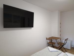 a living room with a tv on a white wall at Ljubljana rest nest in Ljubljana