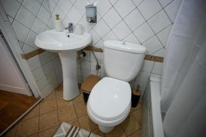 a bathroom with a toilet and a sink at Old Bazaar Balcony Villa in Gjirokastër +42 photos