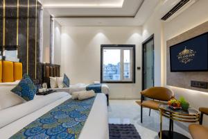 a hotel room with a large bed and a living room at Hotel Byland Inn- Near Connaught Place And 5 Minutes From New Delhi Station in New Delhi