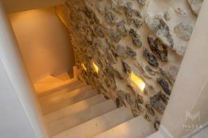 a staircase in a house with a stone wall at Casa Abeurador, con mucho encanto en el centro de Artà in Artá +29 photos