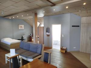 ein Zimmer mit einer Couch, einem Bett und einem Tisch in der Unterkunft Apartment-Design 1, Altendtadt in Altenstadt