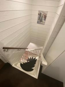 a staircase in a room with a stair case at Port Hotel Ocean Villa in Karlshamn