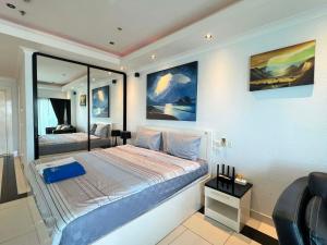 a bedroom with a large bed and a mirror at Viewtalay Beachfront by ND in Pattaya South +216 photos
