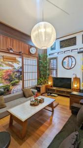a living room with a couch and a table at Hanki Guest House syariah in Gadok 1