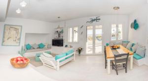 a living room with a table and a dining room at Villa Ione in Mikri Vigla