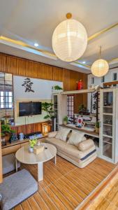 a living room with a couch and a table at Hanki Guest House syariah in Gadok 1