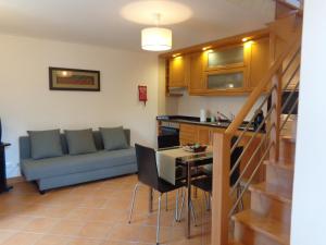 a living room with a couch and a table at Oak Cottage in Ferreira do Zêzere +25 photos