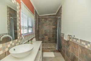 a bathroom with a sink and a shower at Accommodation on 3329 - Unit 2 in Gqeberha +21 photos