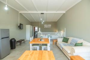 a living room with a couch and a table at Accommodation on 3329 - Unit 2 in Gqeberha