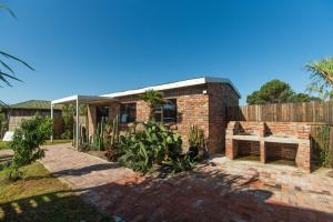 a brick house with a bench in a yard at Accommodation on 3329 - Unit 2 in Gqeberha
