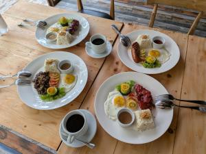 a table with three plates of breakfast food on it at La Bella Boutique Hotel in Tagaytay