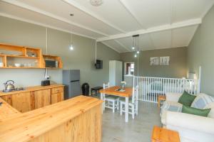 a kitchen and living room with a table and a couch at Accommodation on 3329 - Unit 2 in Gqeberha