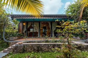 a house with a stone path leading to the front yard at Sim Forest Resort in Phú Quốc