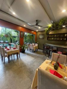 a dining room with tables and chairs in a restaurant at Won Residence & Spa in Siem Reap