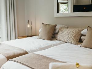 a living room with two beds and a couch at Idube Guest House in Winterton