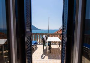 a view of the ocean from the balcony of a house at Blue Horizon Residence in Mitika