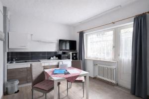 a small kitchen with a table and a table and chairs at Gästehaus Kühnle in Bad Wildbad