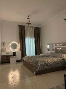 a bedroom with a large bed and a mirror at Private rooms in Sharjah