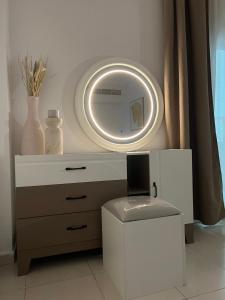 a white dresser with a mirror on the wall at Private rooms in Sharjah +5 photos