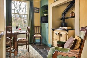 a living room with a table and a chair at Finest Retreats - Bourne Edge in Morland