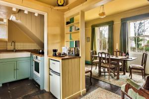 a kitchen with a table and a dining room at Finest Retreats - Bourne Edge in Morland