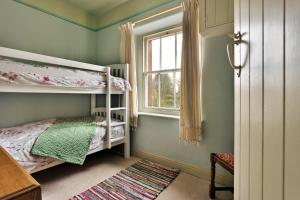 a bedroom with two bunk beds and a window at Finest Retreats - Bourne Edge in Morland
