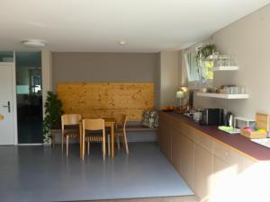 a kitchen with a table and chairs in it at Gästehaus Gutenberg - Self-Check-in in Balzers