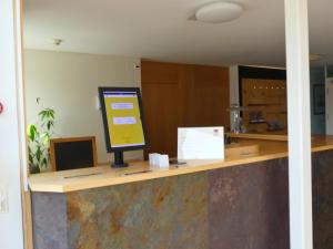a counter with a computer on top of it at Gästehaus Gutenberg - Self-Check-in in Balzers