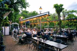 a group of people sitting at tables at a restaurant at Hotel Allegade 10 in Copenhagen