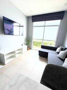 a living room with a couch and a tv at Apartment Karon SeaView 72 sq in Karon Beach +47 photos