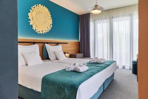 a hotel room with two beds with towels on them at Hotel Nestos in Omiš +29 photos