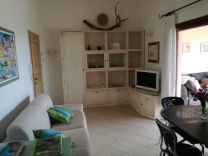 a living room with a couch and a television at Villa Lilly 2 in Punta Molara