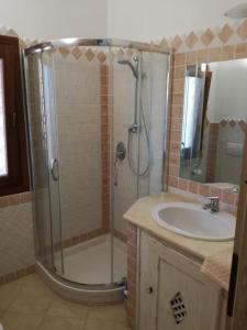 a bathroom with a shower and a sink at Villa Lilly 2 in Punta Molara +30 photos