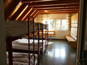 a room with two bunk beds in a attic at Gästehaus Gutenberg - Self-Check-in in Balzers