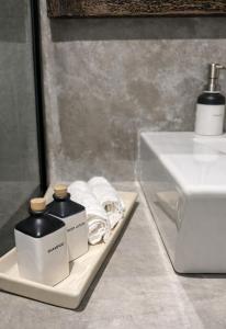a bathroom with two bottles of soap and towels at Stonewater Beach Villa, Negombo in Mahawatta