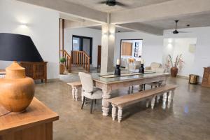 a dining room with a table and chairs at Stonewater Beach Villa, Negombo in Mahawatta +27 photos