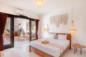 a bedroom with a bed with a teddy bear on it at Cozy villa 2bdr in Seminyak , pool,800m beach in Seminyak