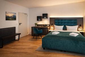 a hotel room with a bed and a desk and a desk at Hotel Hamburg Nord in Norderstedt