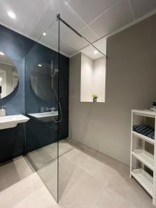 a bathroom with a glass shower and a sink at Santa Pola Suites - Self Check-in near Beach in Santa Pola